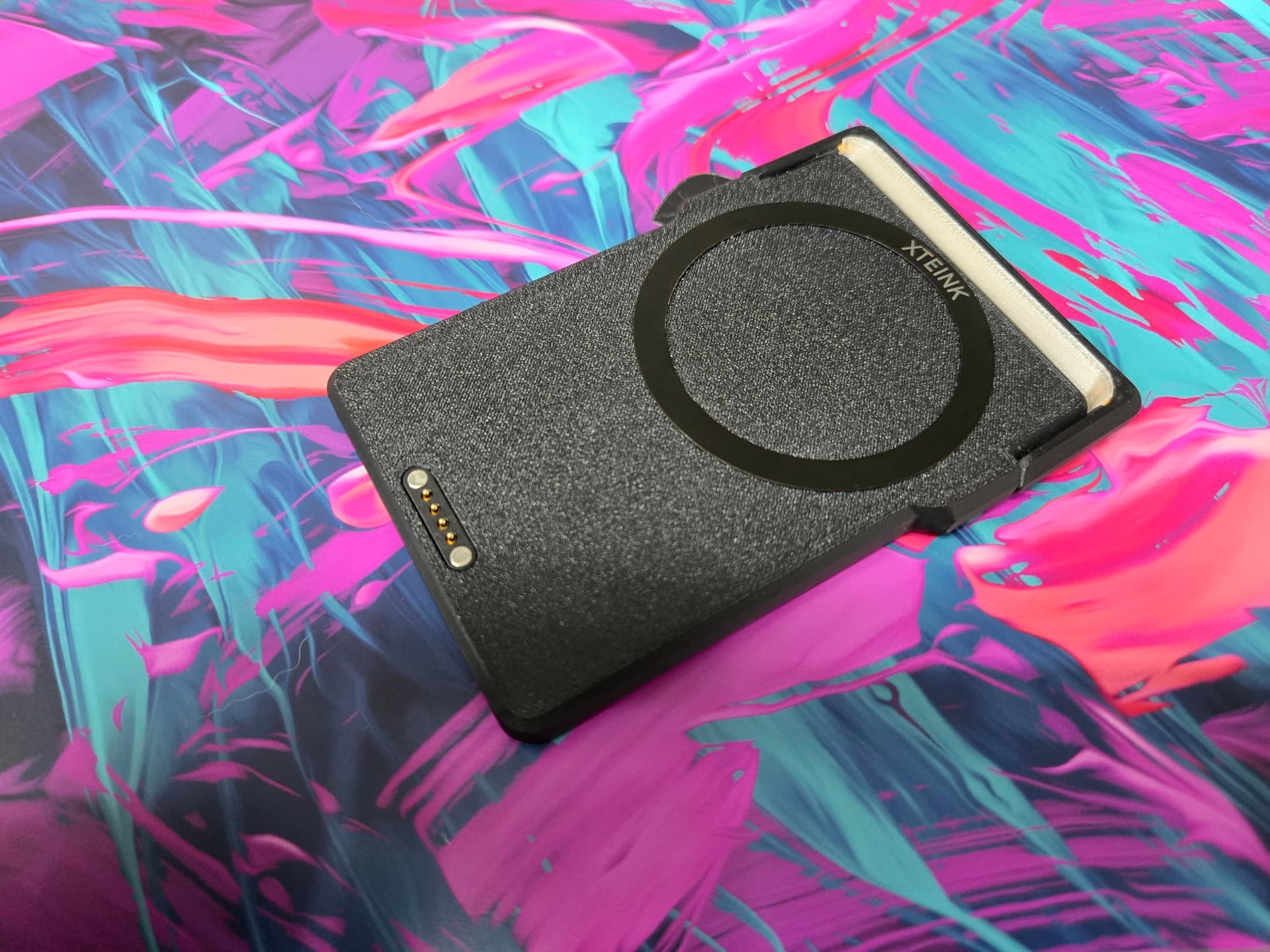 The magnetic alignment ring on the back of the LightCharge alongside the four-pin pogo connector