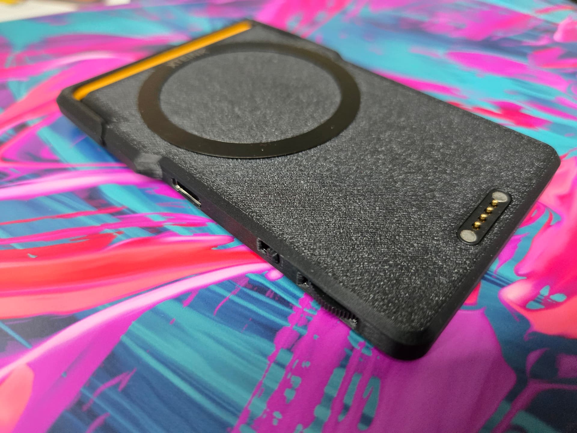 The edge of the LightCharge showing the USB-C port, the slide switches, and the four gold pogo pins