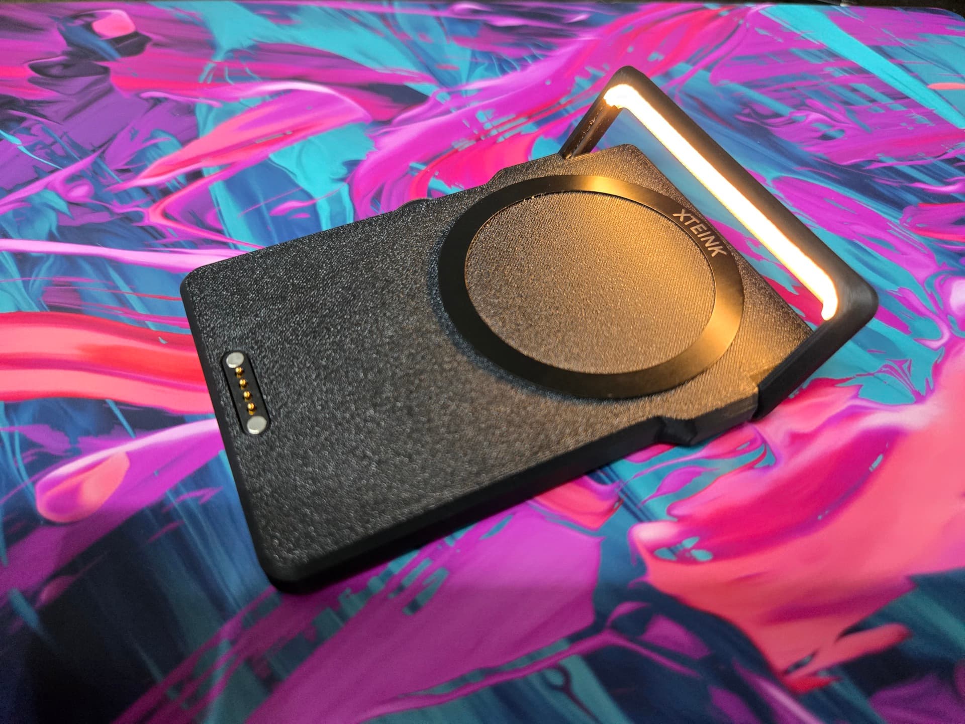 X3 LightCharge with its light arm raised, the diffused 2700K strip glowing warm against the black textured shell