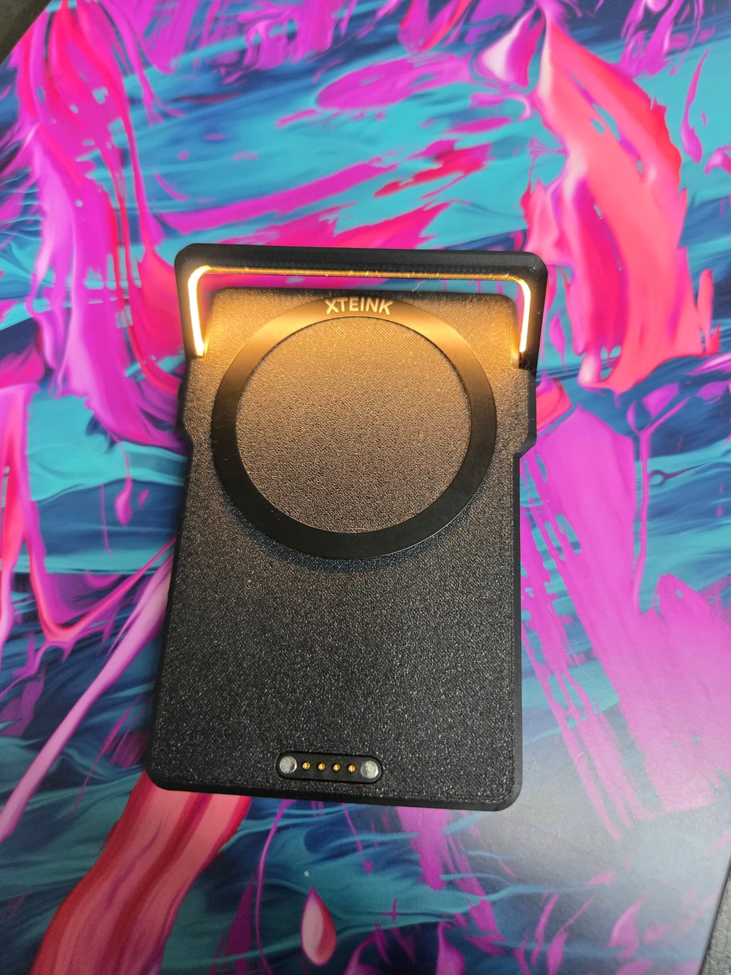 Top-down view of the LightCharge with the arm folded and the warm strip lit along its edge